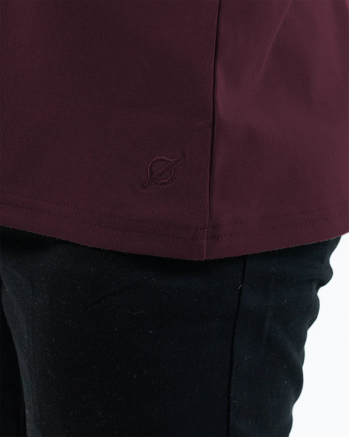 Odyssey Athletic Crew in Plum, hem and embroidered mark close-up